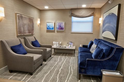 Funeral home reception room with gray and blue seating at Sagel Bloomfield Danzansky Goldberg Funeral Care